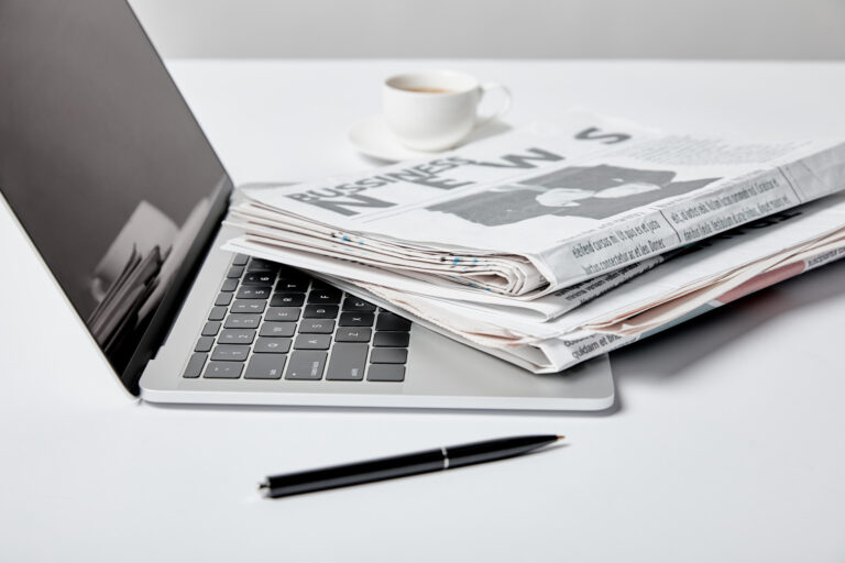 laptop-with-business-newspaper-and-coffee-on-desk-2026-01-06-00-35-00-utc