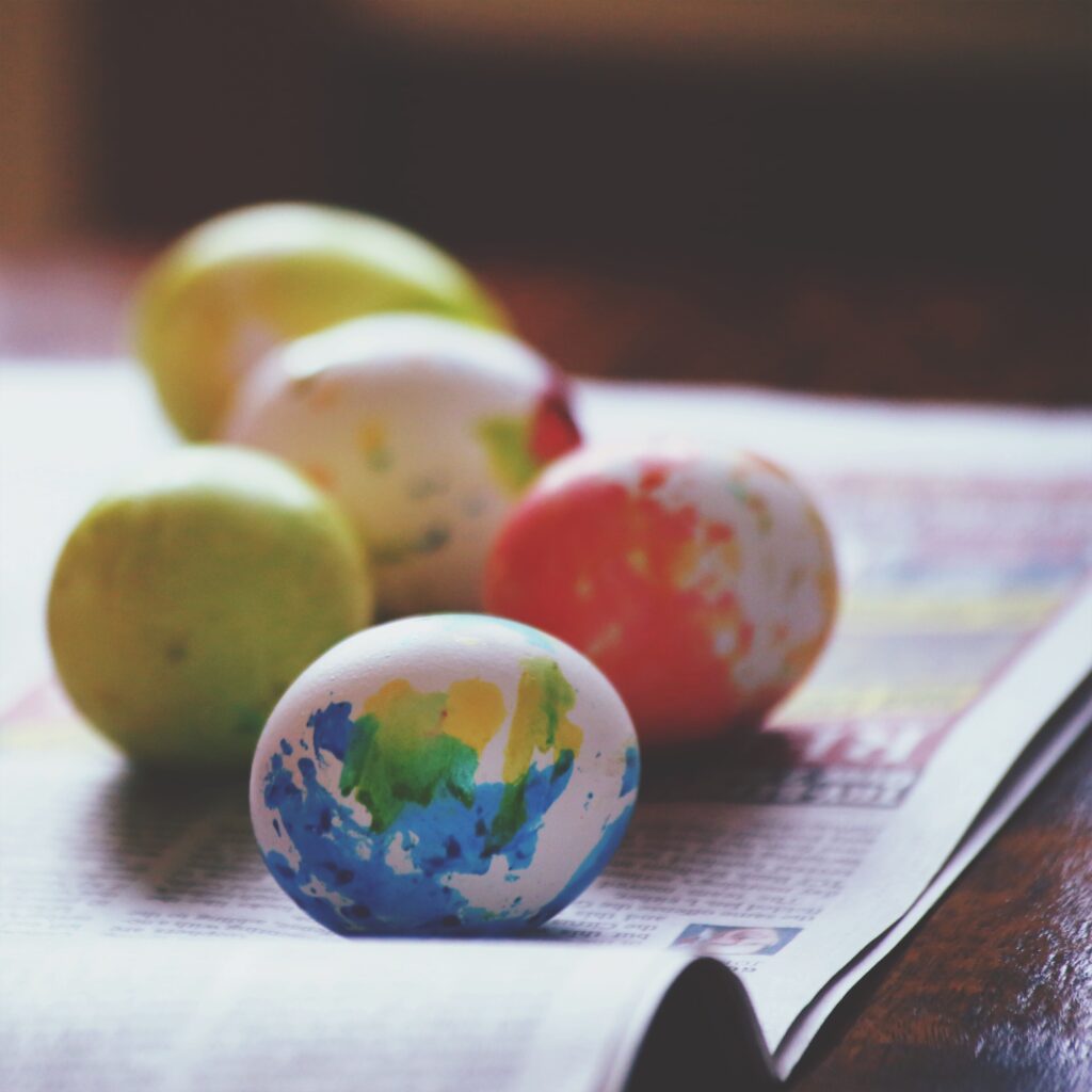 painted-easter-eggs-resting-on-newspaper-indoors-2026-03-09-03-23-06-utc